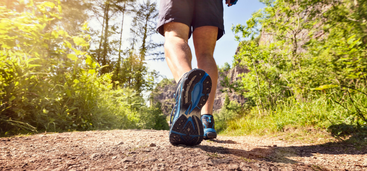 man walking a trail outside